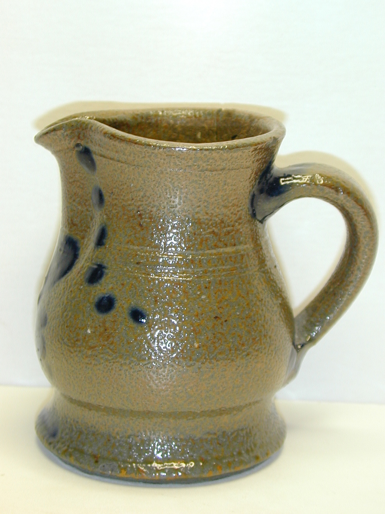 Side view of a small decorated pitcher. ai11.