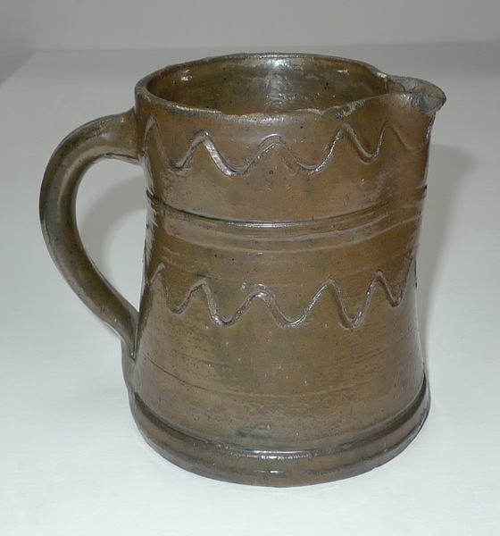 Slip covered pitcher with wavy line decoration. ai31.
