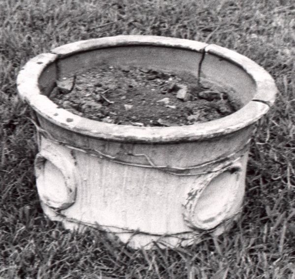 The large low flowerpot found in Lutoraâ€™s yard wired back together prior to restoration. Burbage40.