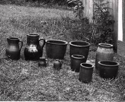 Ten pieces of pottery gathered from the property and displayed on the grass. illus1.