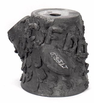 Flowerpot base formed to resemble a tree stump. C. F. Decker is applied in letters made to look like bark covered limbs. T. B. Fleet is incised in script on a flat area which simulates a limb having been cut away. illus29.